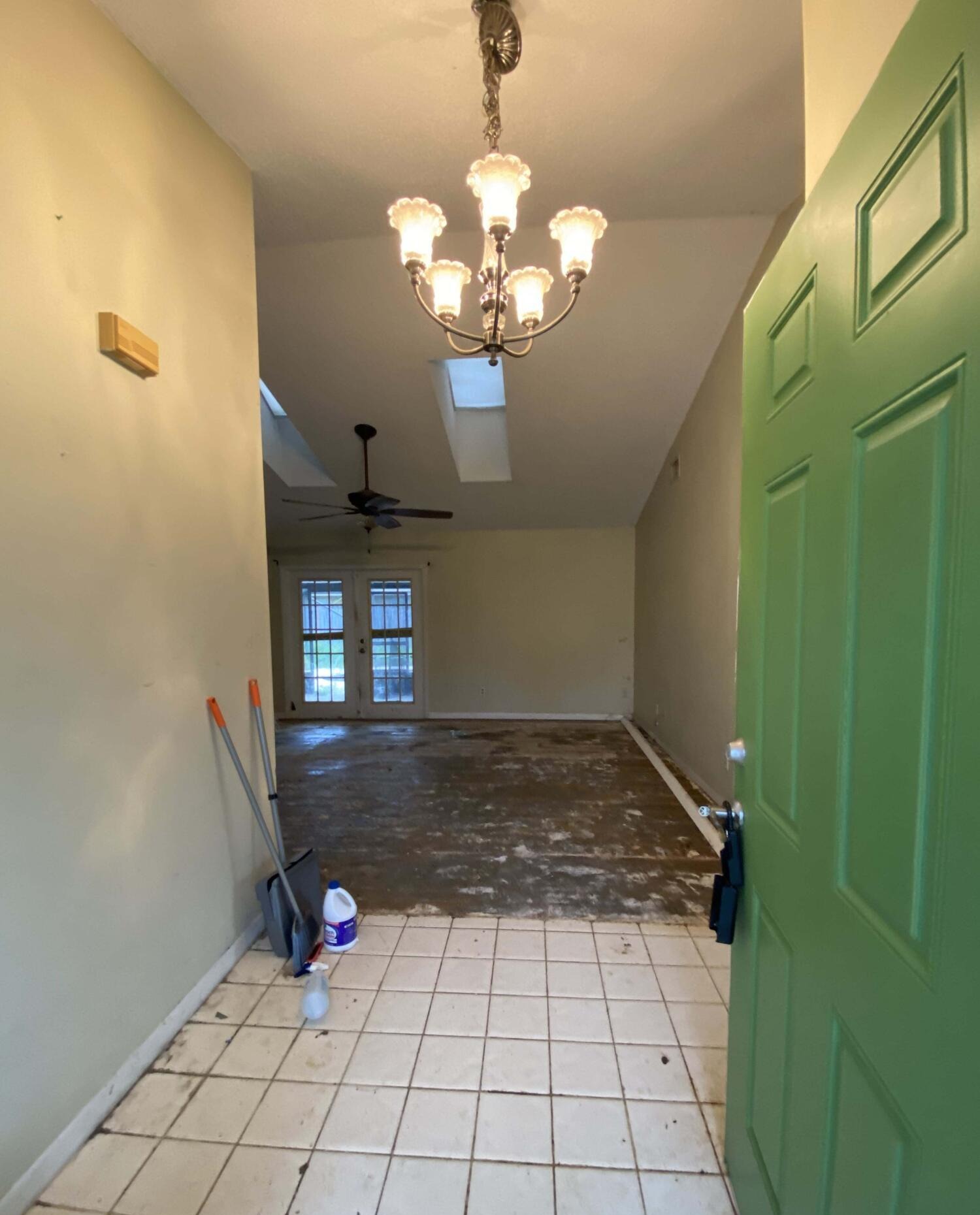 Entry hall with exposed subfloor in a home purchased by Alexta Homes